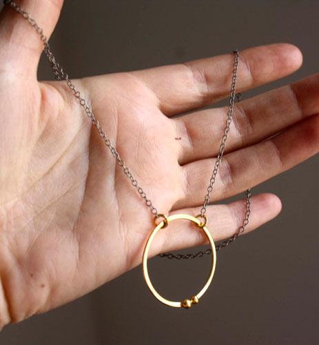 Gold enclosure, circle of the couple necklace in gold and sterling silver