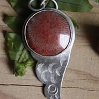 Hiko, bird wing pendant in sterling silver and red coral