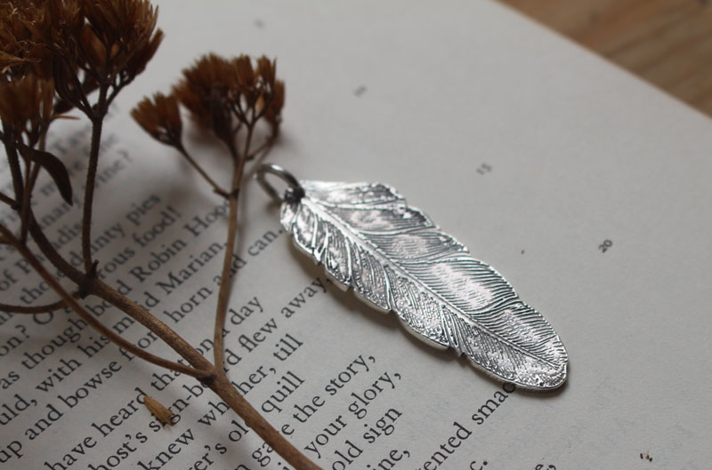 Feather, peace and freedom pendant in silver