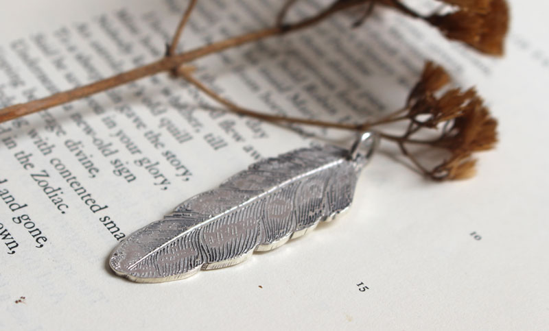 Feather, peace and freedom pendant in silver