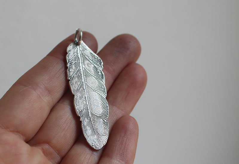 Feather, peace and freedom pendant in silver