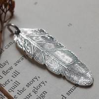 Feather, peace and freedom pendant in silver