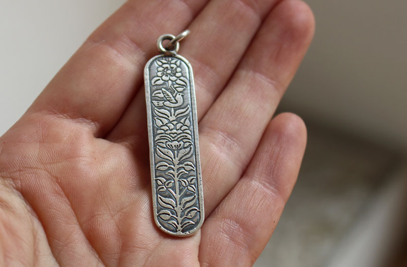 Messenger of life, bird and flower pendant in silver